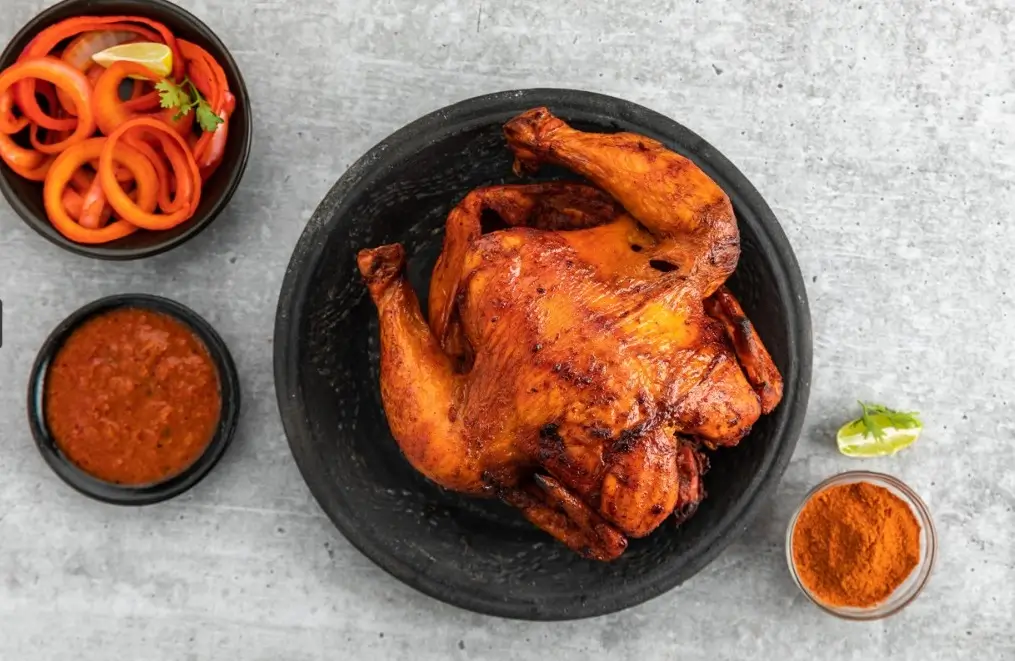 Whole roast chicken with spices and salad