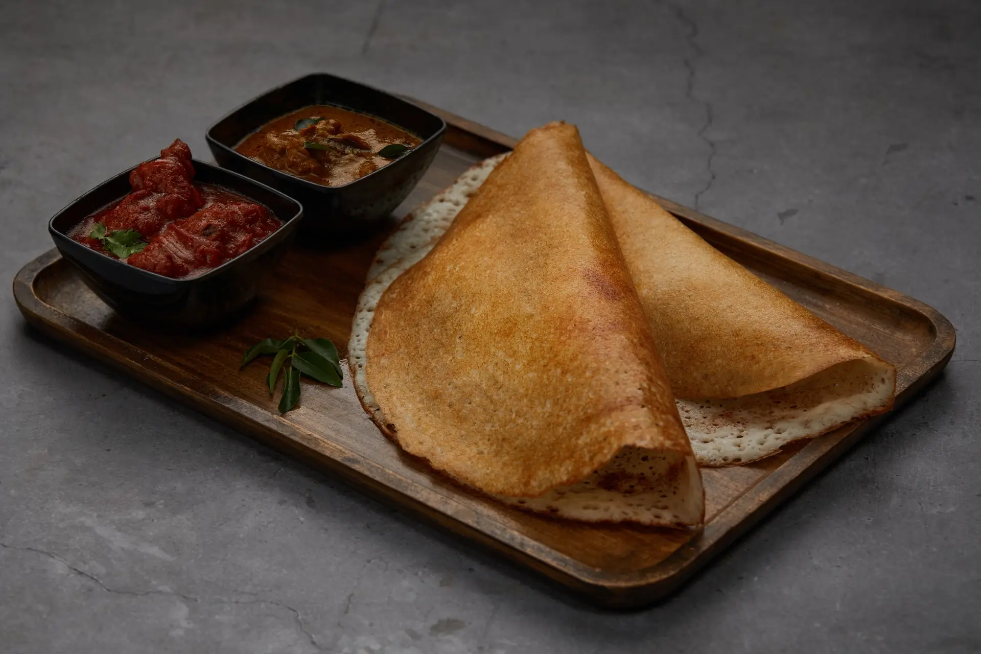 Crisp dosa served with chicken curry and chutney